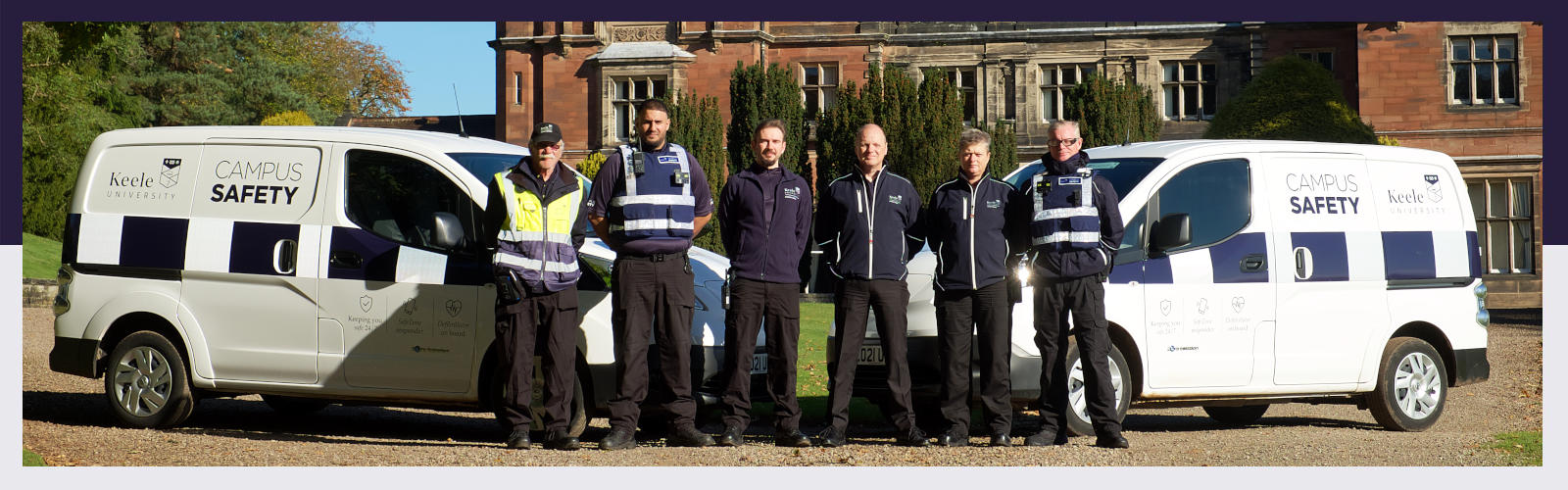 Campus safety team posing in front of Keele Hall