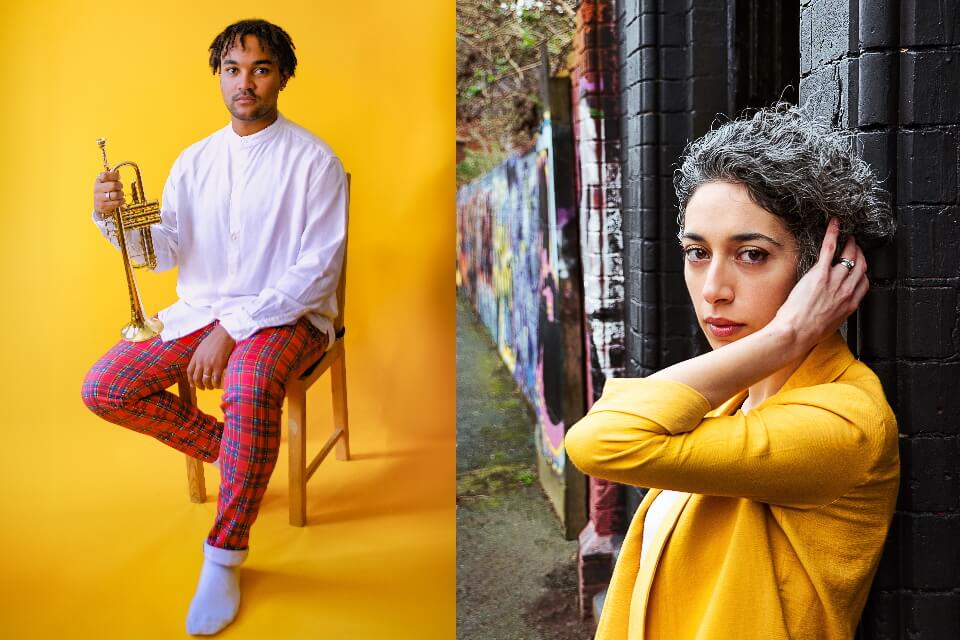 Two performers one on a stool holding a trumpet and the other standing against a wall looking at the camera