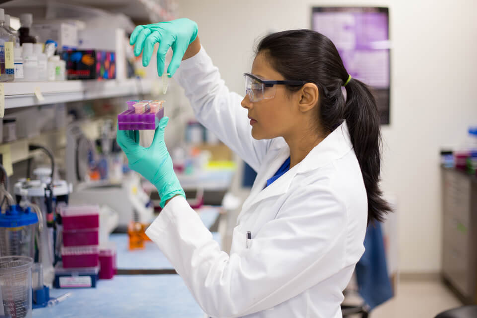 image of scientist holding a test tube