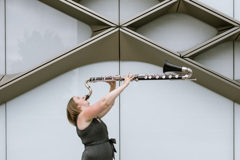 image of performer Sarah Watts blowing a bass clarinet