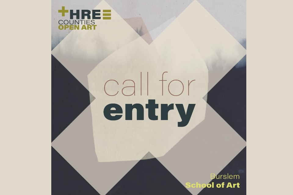 image featuring abstract artwork to the rear in dark greys, black and pale neutrals large cross 