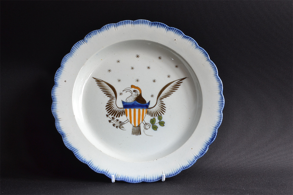 a white ceramic plate white an illustrated eagle