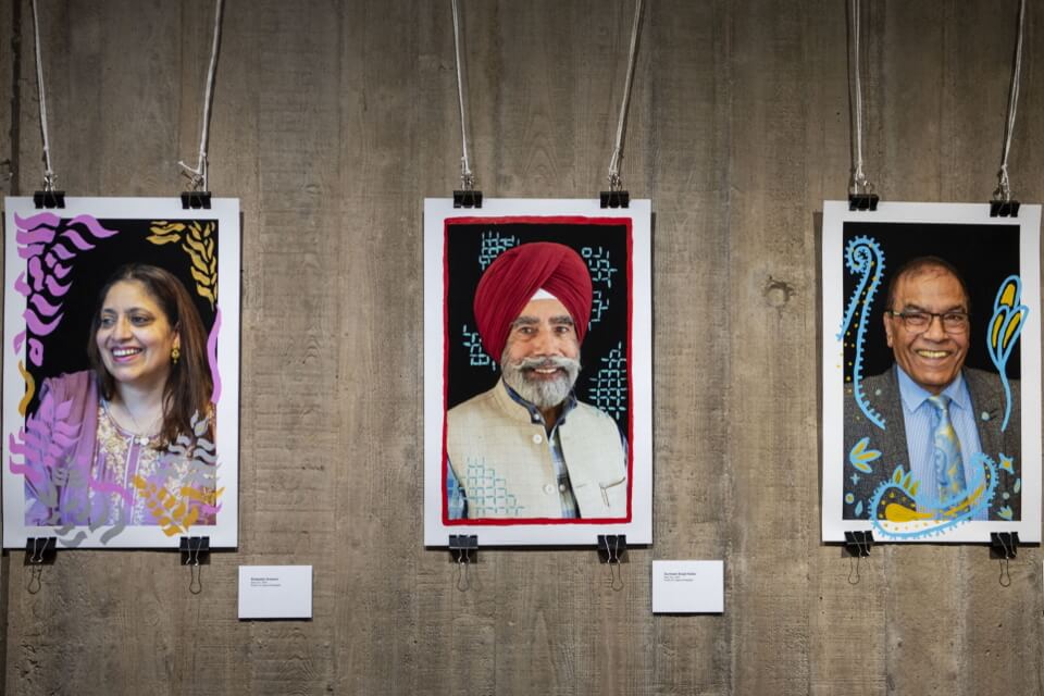 three photos from the exhibition hung in a row two male portraits and one female portrait