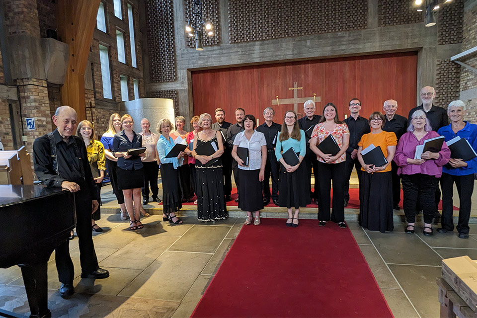 a choir group stands together in the chapel