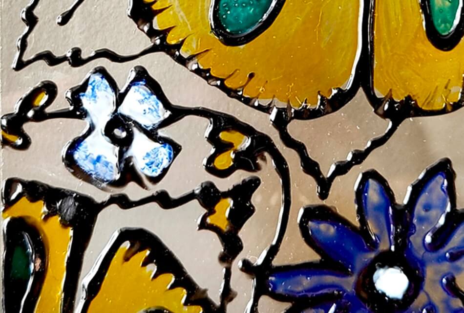 image of flowers in yellow white and blue painted on glass