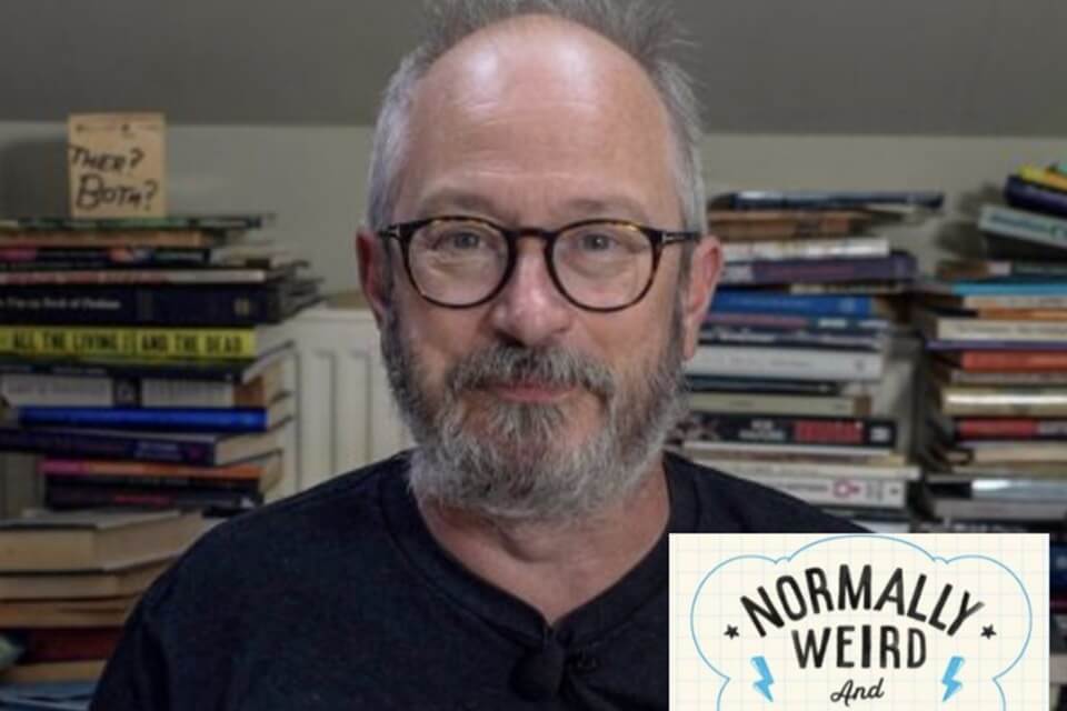 Picture of Robin Ince, wearing glasses, with salt and pepper beard