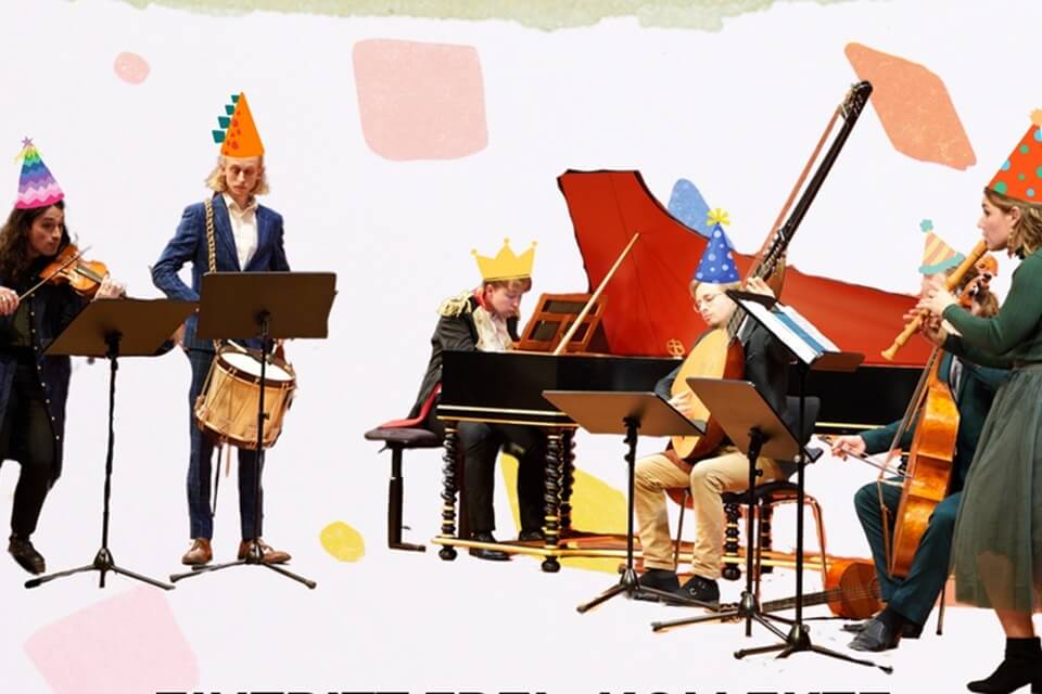 A number of musicians playing a range of instruments, wearing party hats.