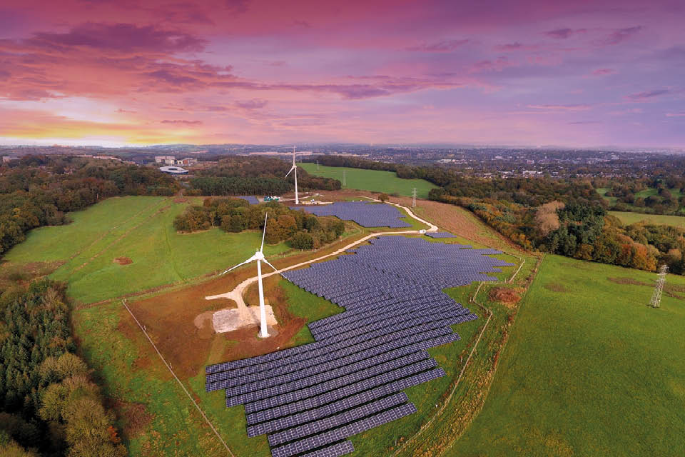 Aerial photo of Keele's Low Carbon Energy Generation Park, showing the two wind turbines and some of the 12,000 solar panels.