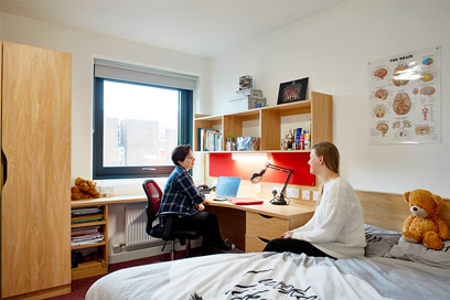 Two students relaxing in their room in Barnes Y block
