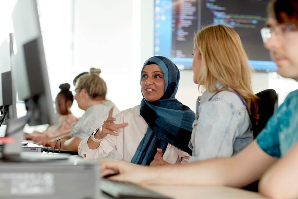 Data Science students at a computer