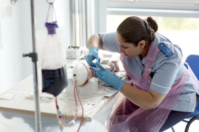 Student undertaking venapuncture