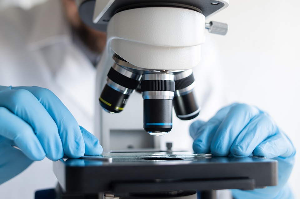 Microscope examining a slide