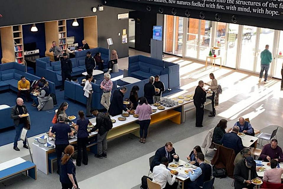 People networking in the Denise Coates Foundation Building at Keele University
