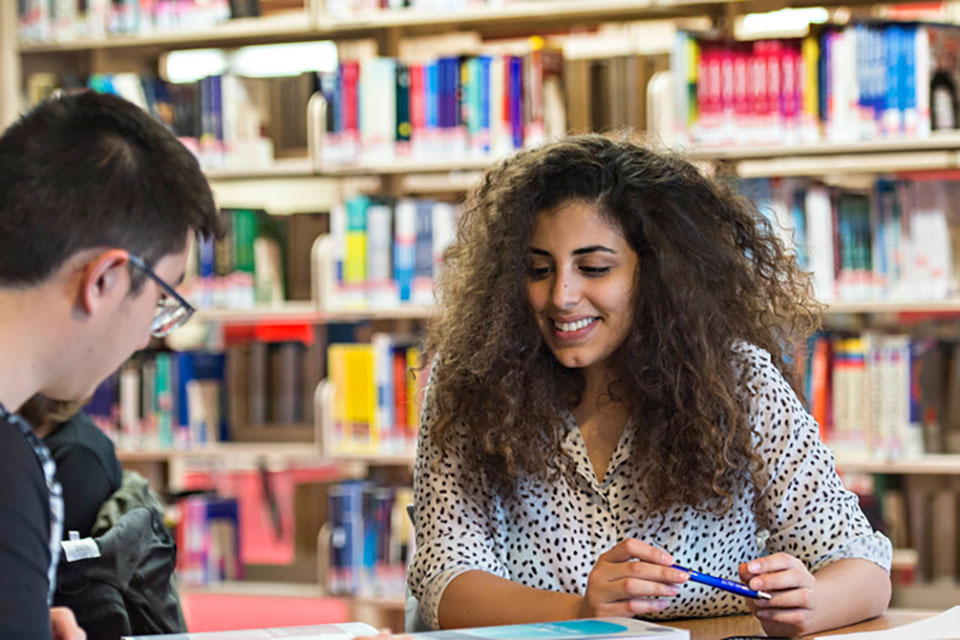 Young person smiling whilst collaborating