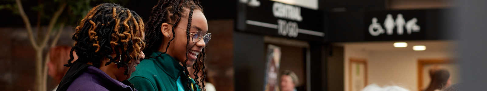 A parent and child talking to university staff at a Keele University open day