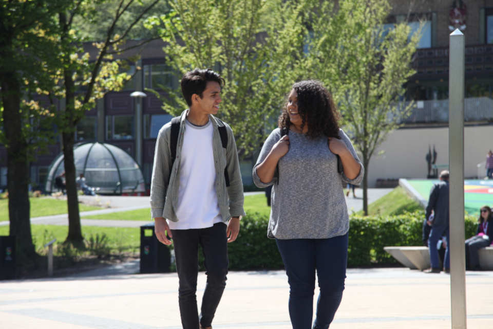 Two students walking on campus