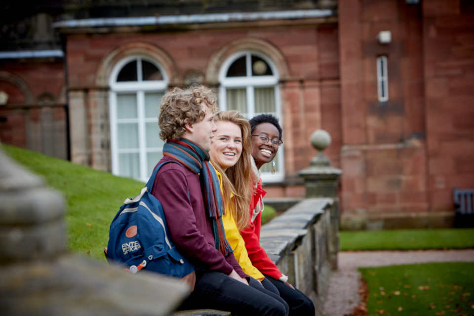 A group of students sat outside Keele Hall