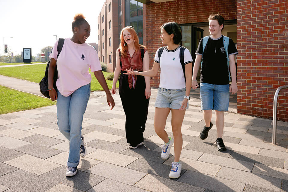 Learn, stay and explore - students outside accommodation building