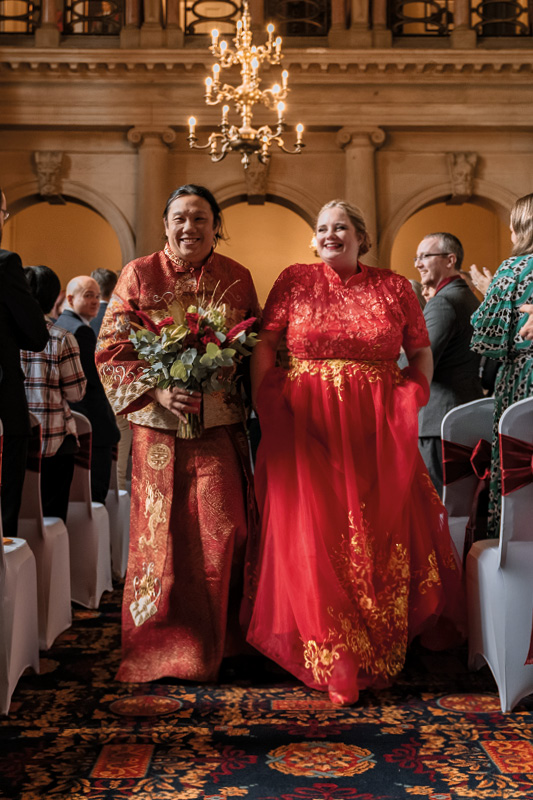 Wedding couple walking down the aisle in Keele Hall