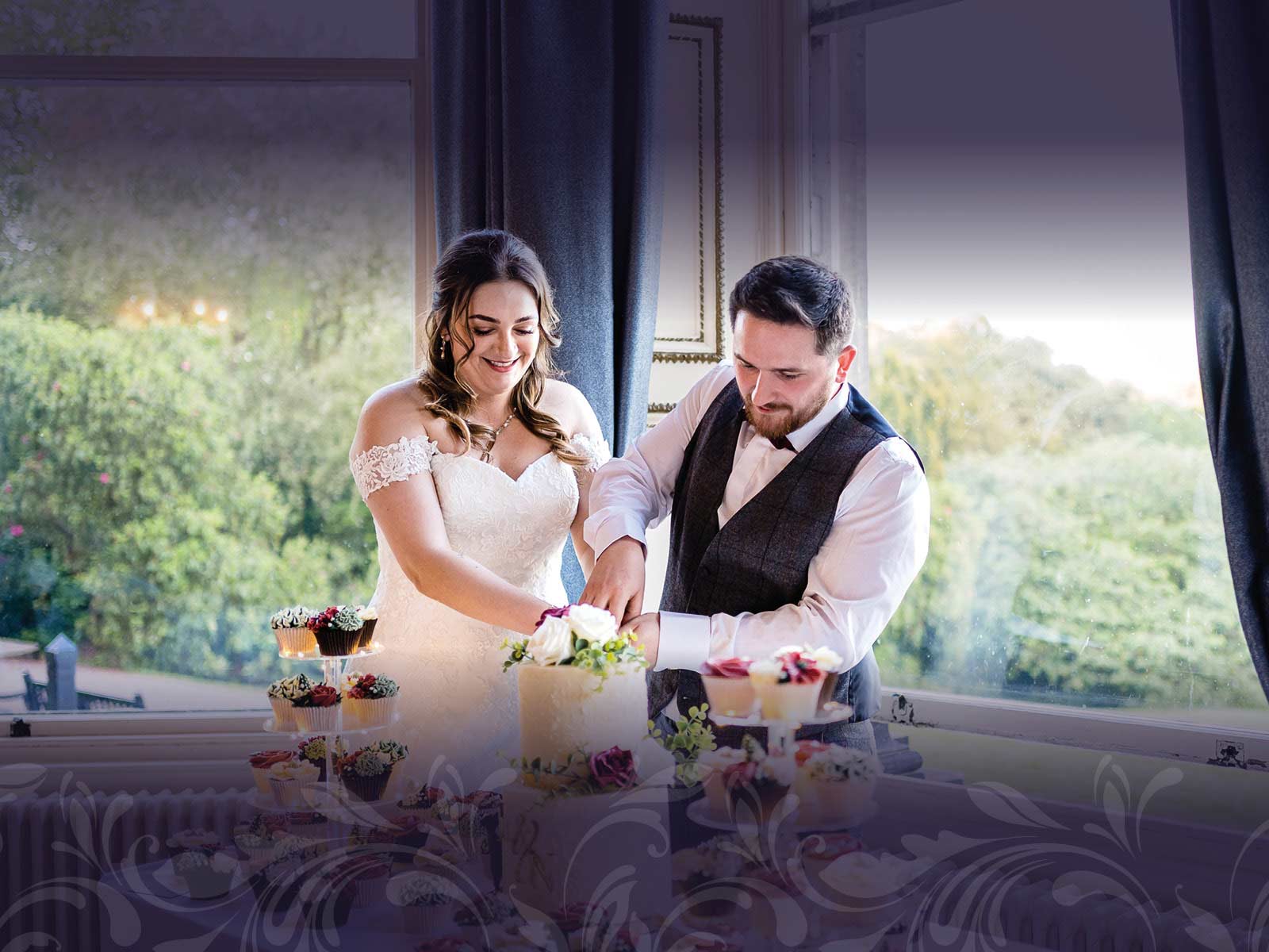 Newly married couple cutting their wedding cake