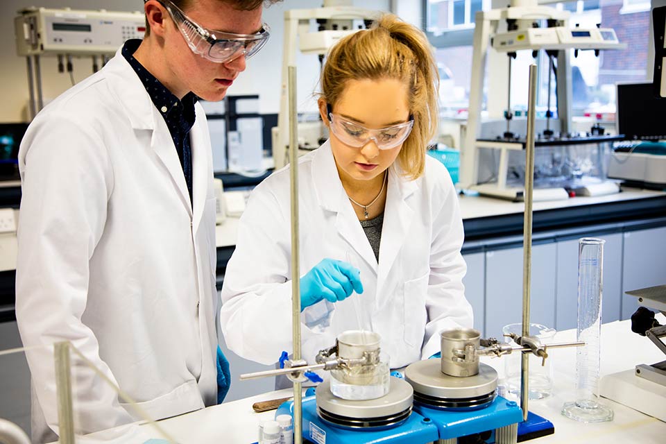 Two Keele University students in a laboratory carrying out an experiment/