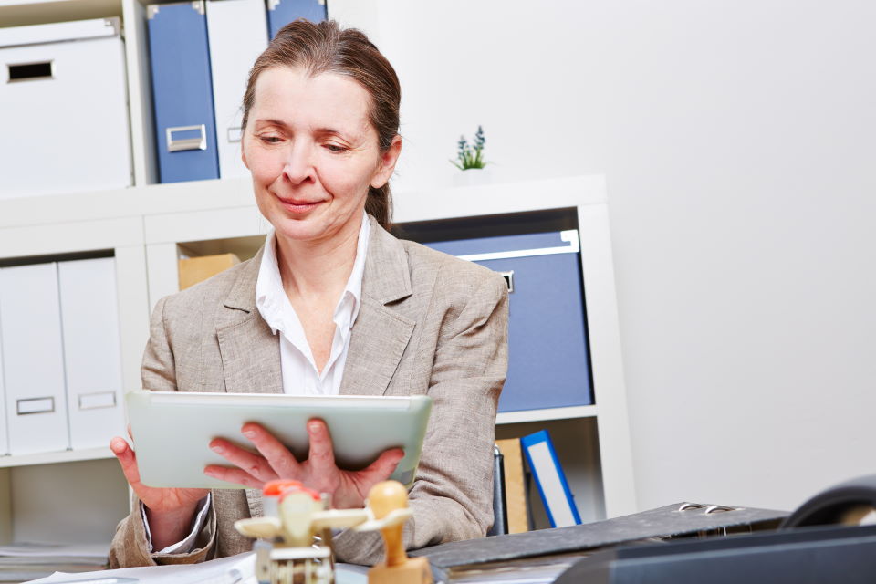 gp reading an ebook in an office