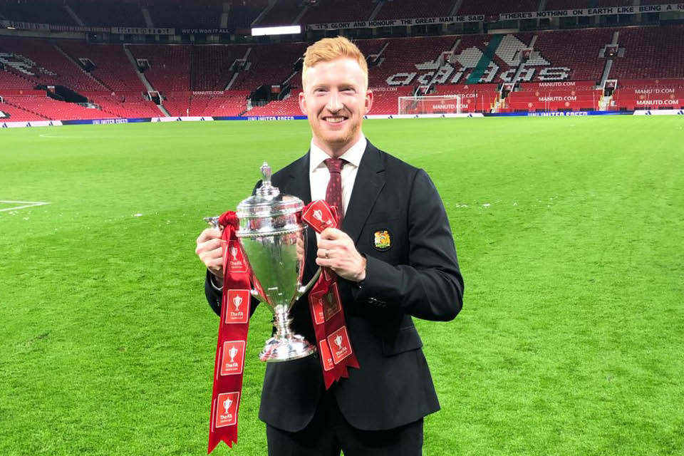 Dr Matthew Lancett holding cup at Old Trafford ground 