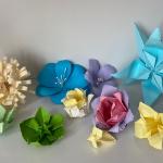 a selection of colourful origami flowers on a table