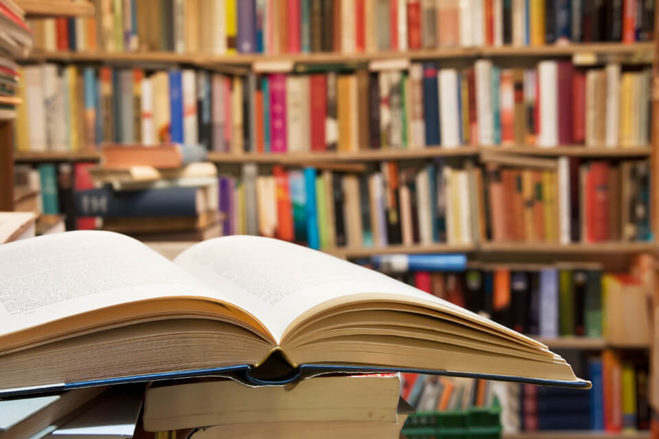 Open book in front of bookcase 