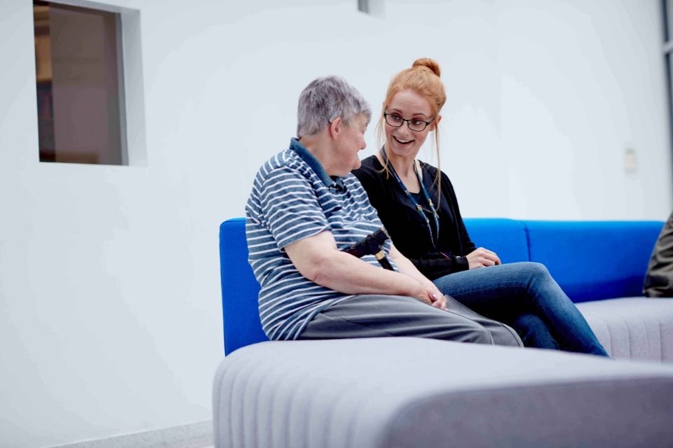 Social worker with patient in a clinical setting