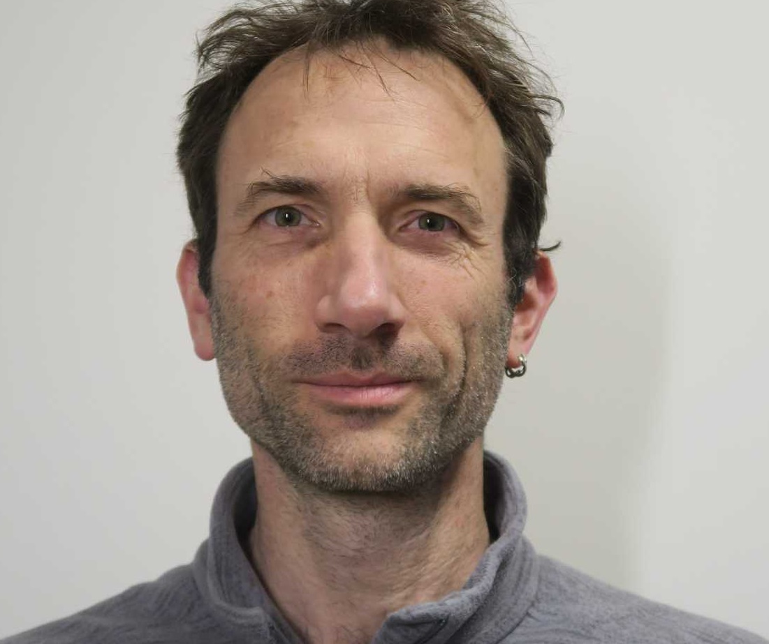 Image of Christian Devenish, Lecturer in Ecology and Environment, wearing a grey fleece.