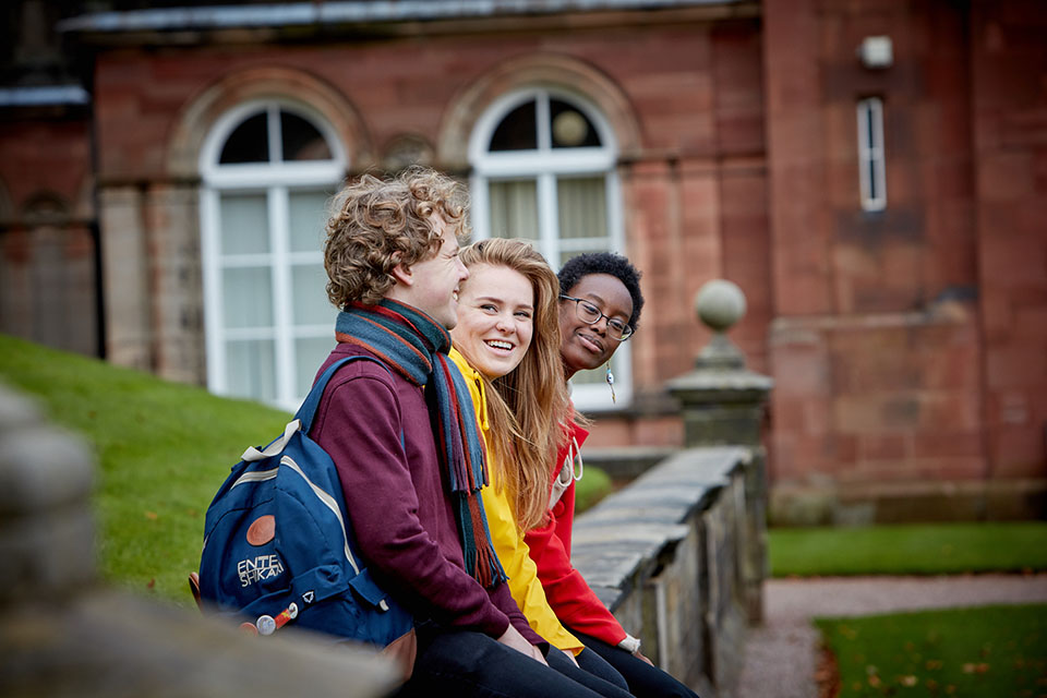 Students sitting outside Keele Hall