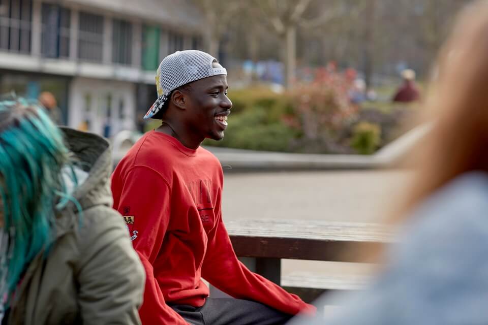 Student sitting in Union Square on Keele campus