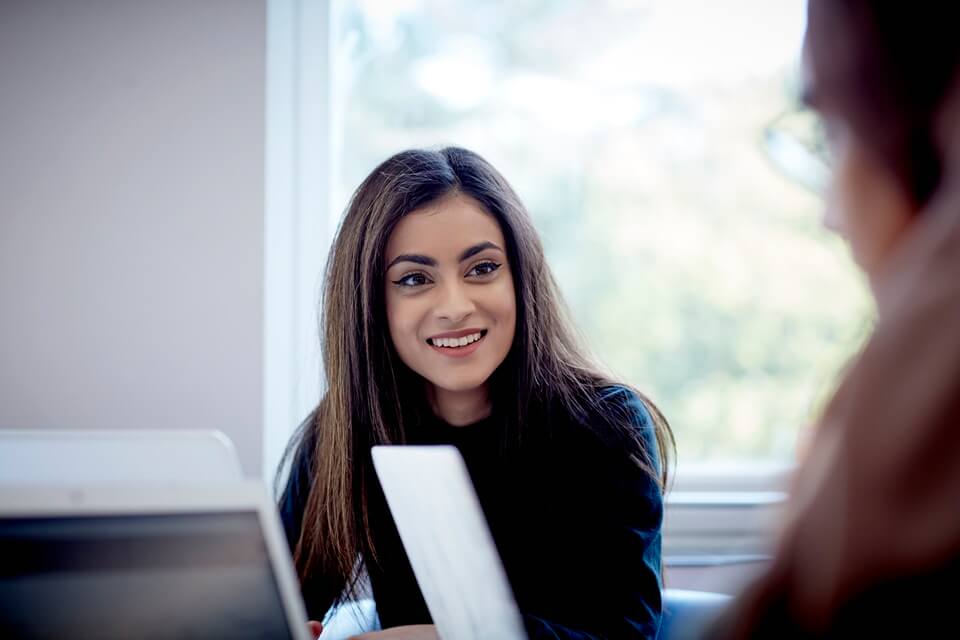 Student smiling in library