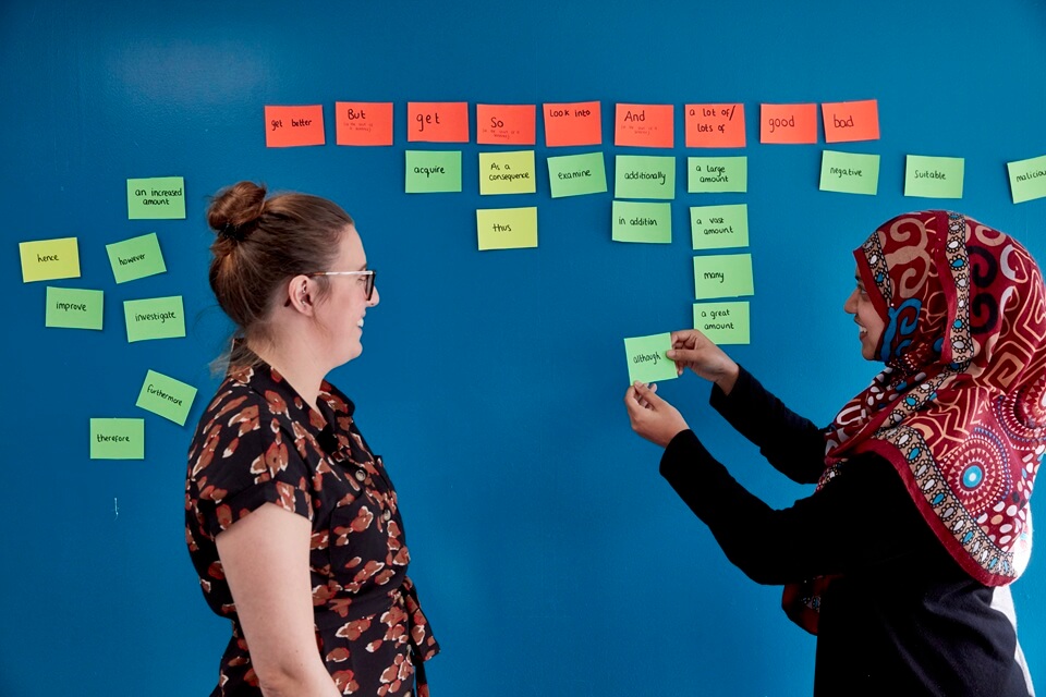 Two people using post it notes 