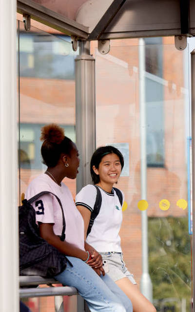 Keele students at a bus stop on Keele University campus