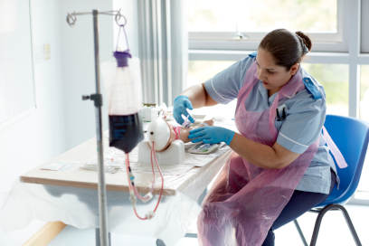 A student nurse undertaking a practical activity as part of their course.