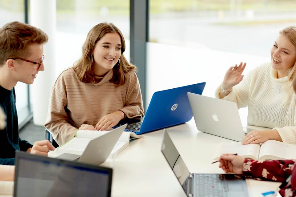 Students sitting with laptops in Keele Business School
