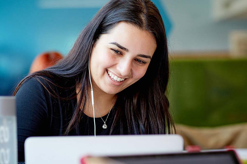 Student smiling with headphones in