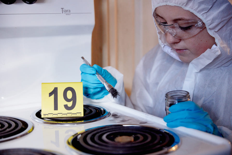Forensic Biology student gathering evidence from cooker