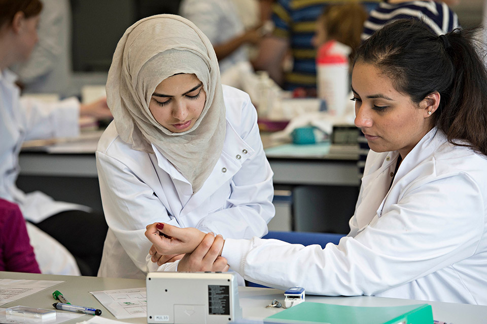 Two students studying medicine at Keele undertaking a practical activity in a laboratory.