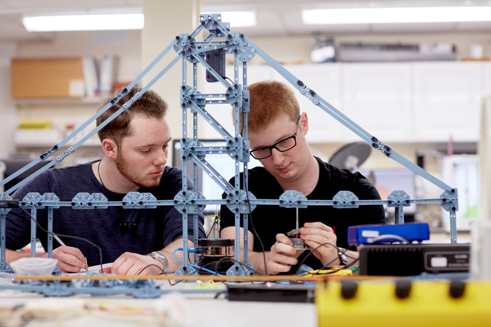 students working with physics equipment