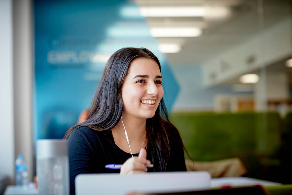 Student smiling in library