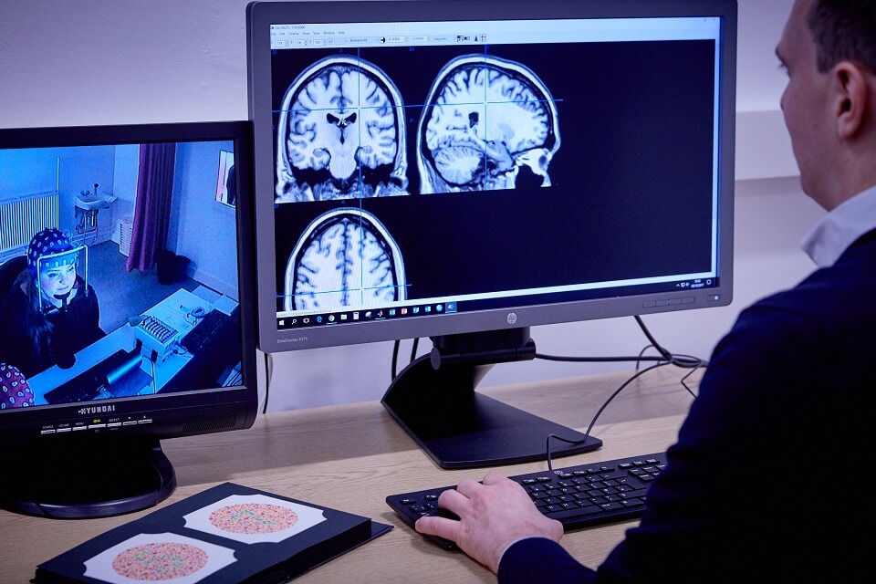 Keele Psychology with Neuroscience lecturer looking at brain scans in lab