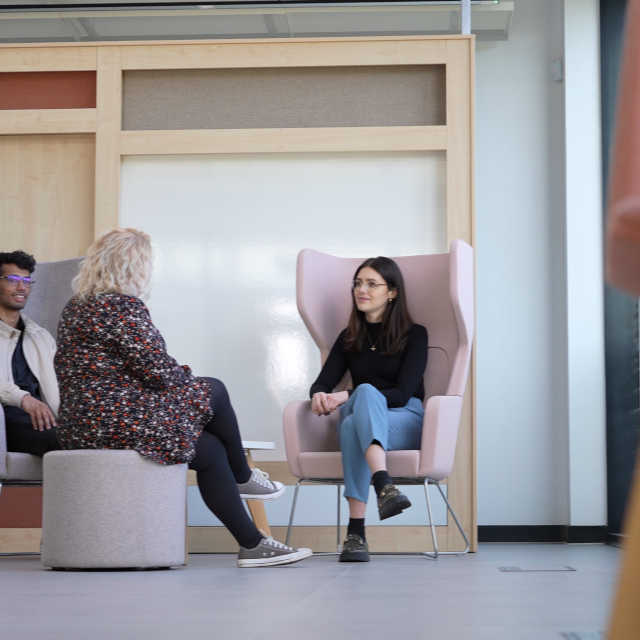 Photo of Katie talking to a colleague