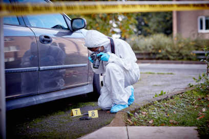 A Forensic Science student processing a car as part of our crime scene facilities.