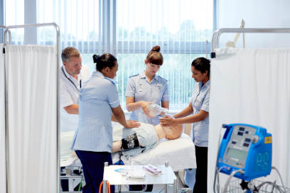 A group of nursing students undertaking a practical activity during their studies.