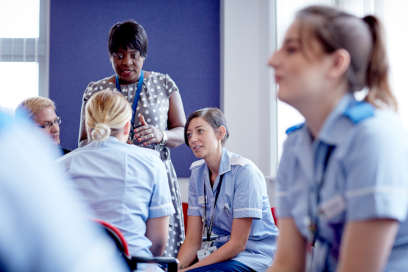 A group of nursing students talking to their lecturer.