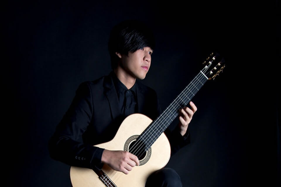 Image of Julian playing classical guitar