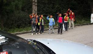 Japanese Children Waving at a car passing